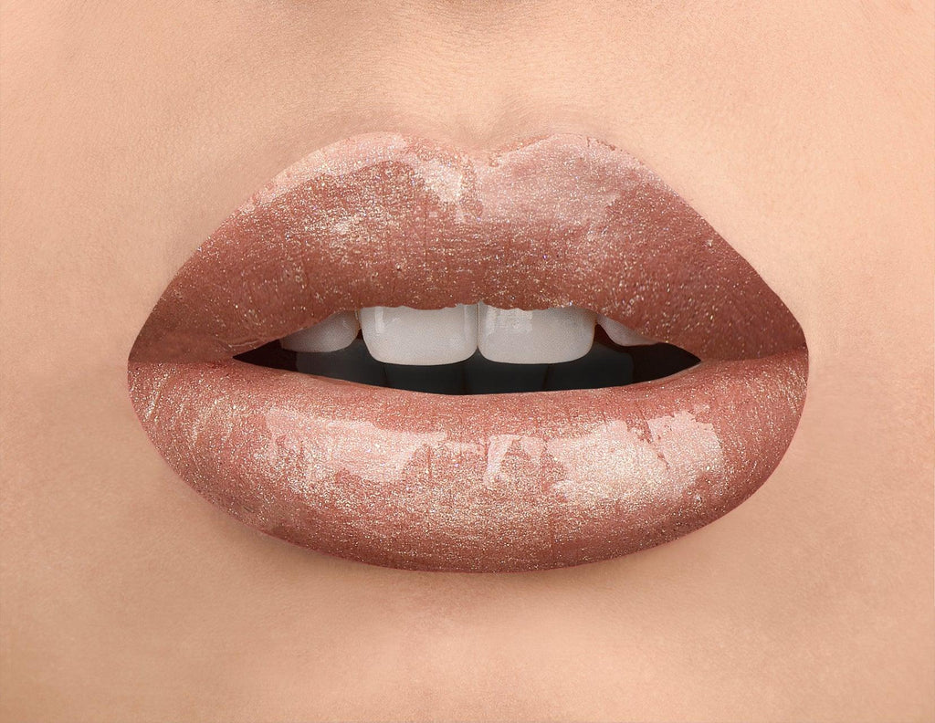 Feeling fancy? Toast up with this high shine lip strobe is the perfect topper for champagne-inspired looks. With a sheer, prismatic bronze tint and rose gold reflections, this lip gloss will help you achieve that elevated look. Wear it alone for a natural glow or layer it over your favorite lipstick for an instant pop of color.